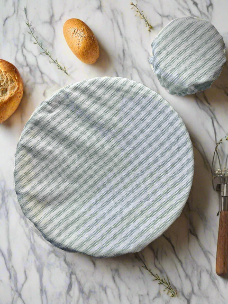 Two round, striped fabric covers on a marble surface