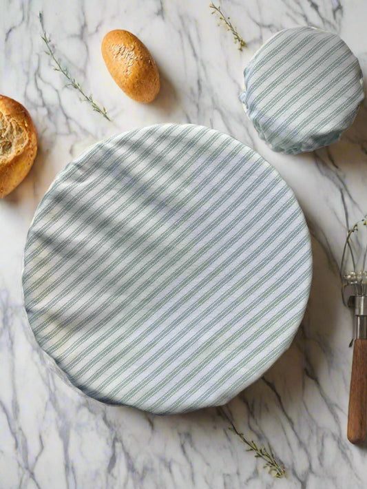 Two round, striped fabric covers on a marble surface